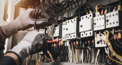 Electrician Working on Electrical Panel
